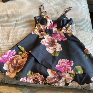 Floral fun dress. It lays pretty straight just layer it wide to show detail